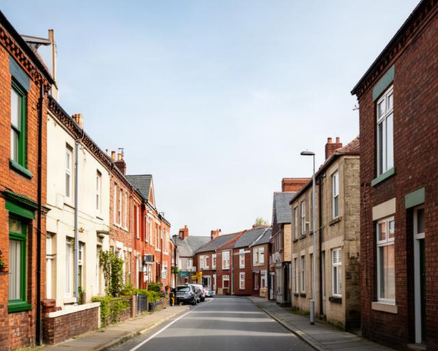 Spellow Lane in Liverpool with local terraced buildings and a clear city street view